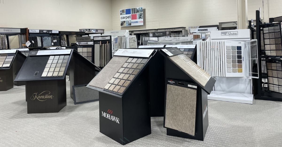 Floors USA showroom displaying a variety of carpet samples in different colors and textures arranged for viewing.