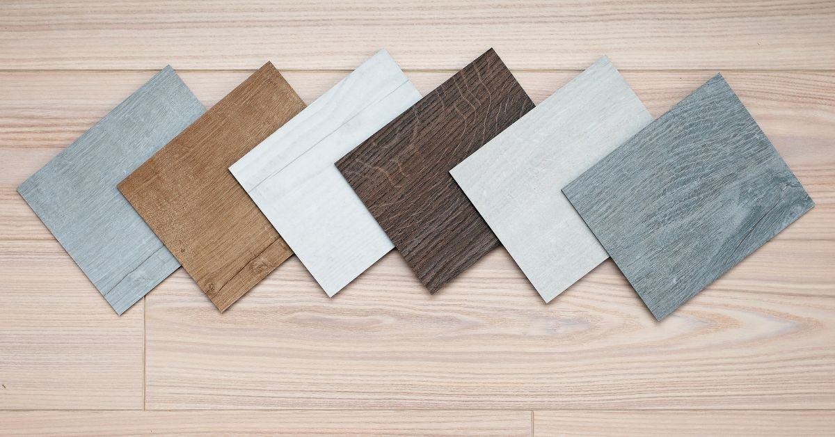 A collection of wood flooring samples showcasing different colors, textures, and finishes arranged on a display board.
