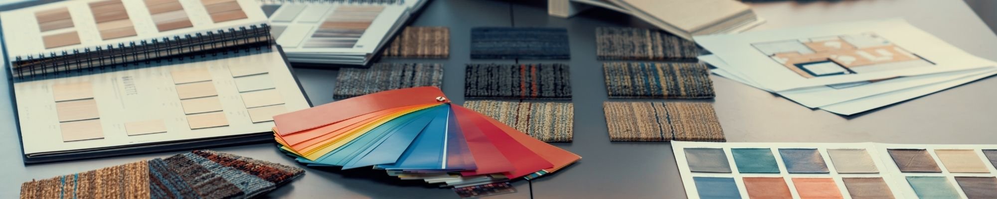 A collection of colorful paint samples arranged on a table, highlighting a spectrum of hues for selection.