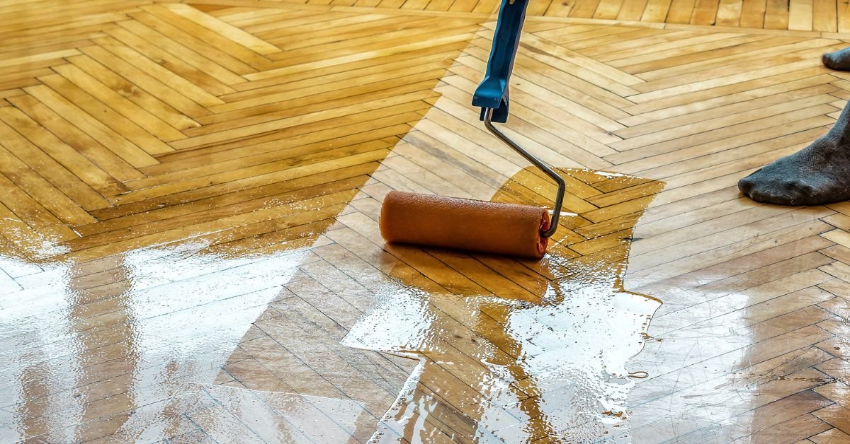 Individual applying a paint roller on a wooden floor, showcasing an innovative method for cleaning surfaces.