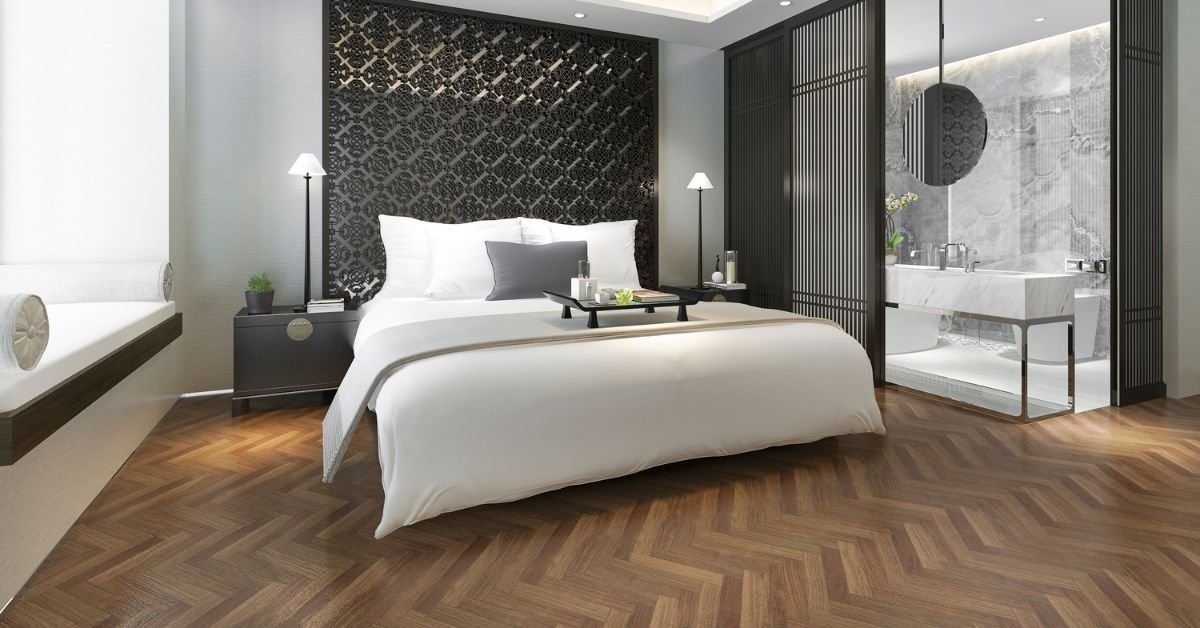 A modern bedroom featuring a large bed, stylish decor, and polished wooden flooring.