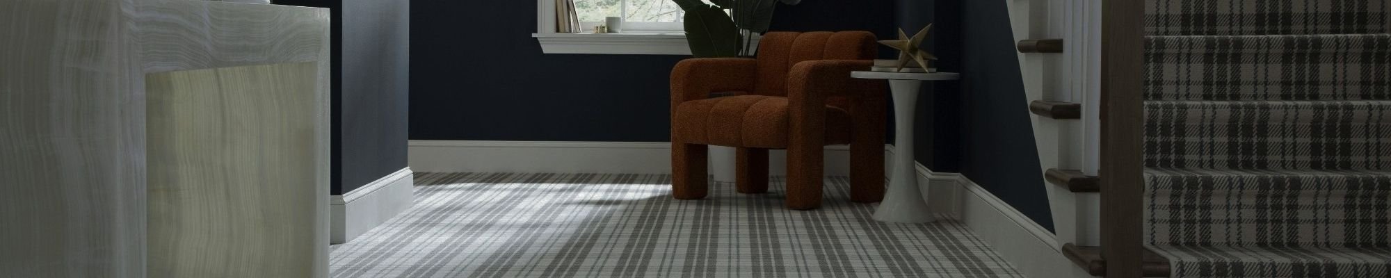 A hallway featuring a blue wall and a white and grey checkered floor, creating a modern and stylish atmosphere.