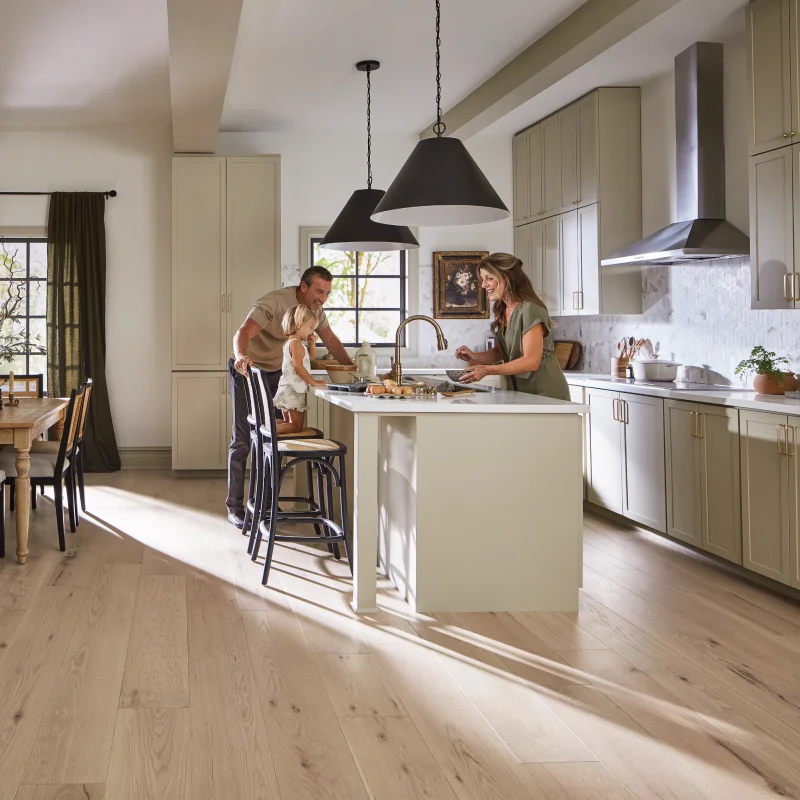 Family standing around the kitchen island enjoying time together