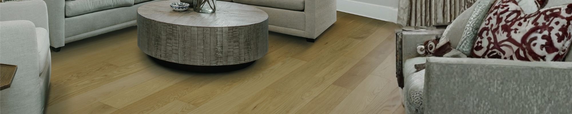 A cozy living room featuring a couch, a coffee table, and a dining table, creating a welcoming atmosphere.