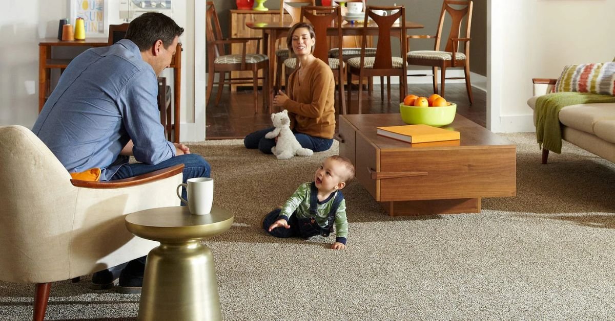 A family sits together in a cozy living room, with a baby in their midst, enjoying a moment of togetherness.
