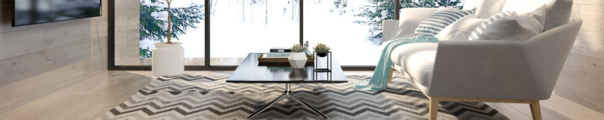 A modern living room featuring a stylish couch, a coffee table, and a television against a neutral backdrop.