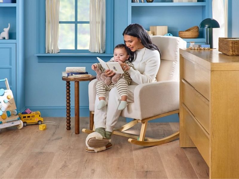 A woman and a child sitting together in a rocking chair, sharing a moment of comfort and connection.