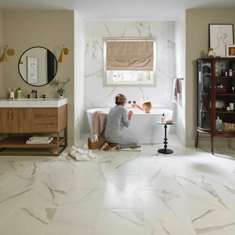 Mother playing with her child while giving him a bath