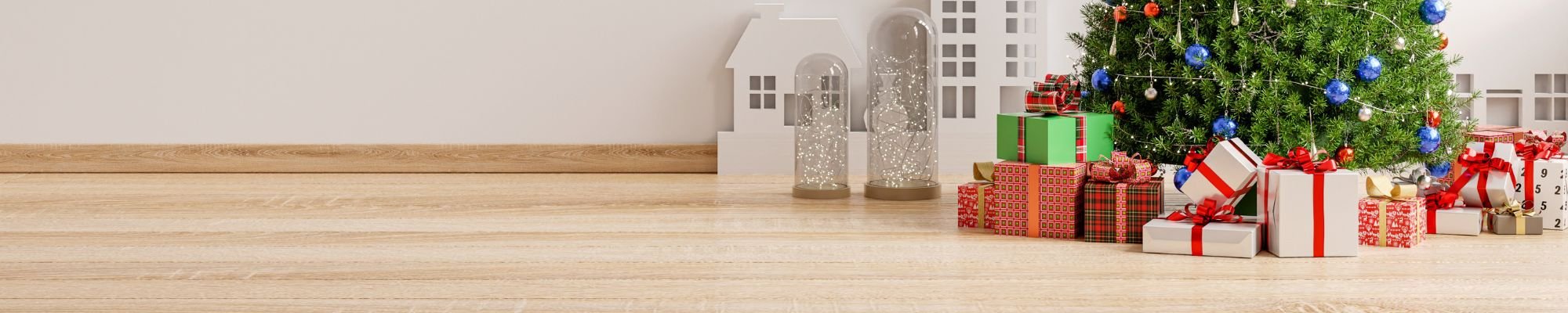 A decorated Christmas tree surrounded by colorful gifts on a wooden floor, creating a festive holiday atmosphere.